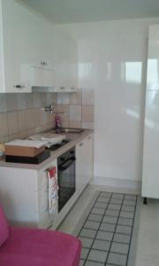a kitchen with a sink and a stove top oven at Apartments with a parking space Split - 11726 in Split
