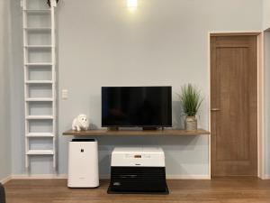 a living room with a tv on a wooden shelf at DAISHO - Vacation STAY 36303v in Hokuto