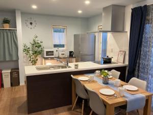 a kitchen with a table and a sink and a counter top at DAISHO - Vacation STAY 36303v in Hokuto