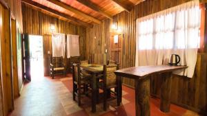 a room with a table and chairs in a house at CABAÑAS SOLTAME CARNAVAL in Puerto Iguazú