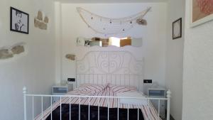 a childs bedroom with a white bed in a room at Family friendly house with a swimming pool Puljane, Krka - 11688 in Oklaj