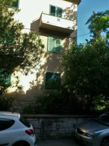 a white car parked in front of a building at Apartments with WiFi Split - 11667 in Split