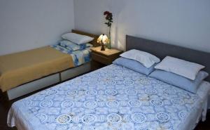 a bedroom with two beds and a table with a lamp at Apartments with WiFi Split - 11667 in Split