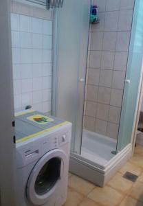 a washing machine in a bathroom with a shower at Apartments with WiFi Split - 11667 in Split