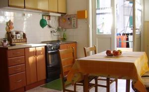 a kitchen with a table with a bowl of fruit on it at Apartments with WiFi Split - 11667 in Split