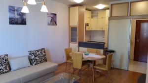 a small living room with a table and a couch at Apartments with WiFi Split - 11784 in Split