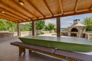 a green ping pong table on a patio at Apartments and rooms by the sea Nerezine, Losinj - 11815 in Nerezine