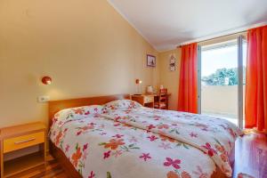 - une chambre avec un lit et une grande fenêtre dans l'établissement Apartments and rooms by the sea Nerezine, Losinj - 11815, à Nerezine