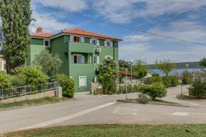 a green house on the side of a road at Double Room Nerezine 11815a in Nerezine