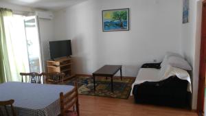 Schlafzimmer mit einem Bett, einem Tisch und einem TV in der Unterkunft Apartments with a parking space Vir - 11812 in Vir