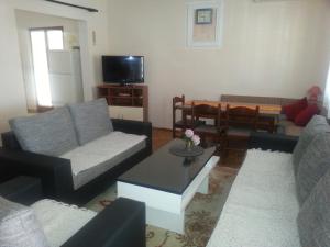a living room with two couches and a table at Apartments with parking space Orebic, Peljesac - 11834 in Orebić