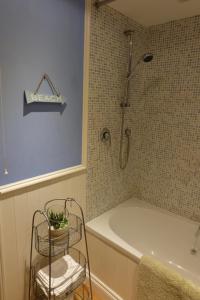 a bathroom with a shower and a tub and a sink at Colegate 4 Bed townhouse in Norwich