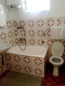 a bathroom with a toilet and a sink at Apartments by the sea Podgora, Makarska - 11888 in Podgora