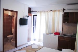 a bathroom with a sink and a toilet and a television at Apartments and rooms by the sea Podgora, Makarska - 11893 in Podgora