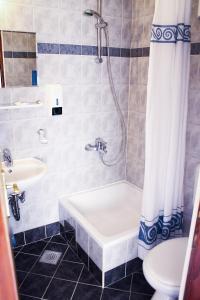 a bathroom with a tub and a sink and a toilet at Apartments and rooms by the sea Podgora, Makarska - 11894 in Podgora