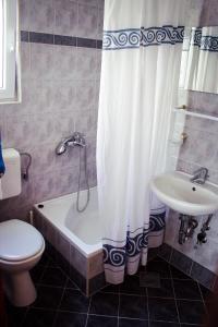 a bathroom with a toilet and a tub and a sink at Apartments and rooms by the sea Podgora, Makarska - 11894 in Podgora
