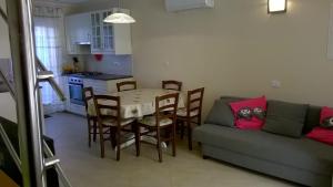 a living room with a table and a couch at Holiday house with WiFi Susak, Losinj - 11911 in Susak