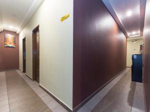 a hallway with brown and white walls and a sign on a wall at Silibin Times Inn Hotel in Ipoh