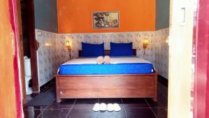 a bedroom with a bed with two slippers on it at Club Resort MATAHARI in Gili Trawangan