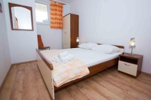 a bedroom with a large bed and a mirror at Apartments by the sea Zuljana, Peljesac - 12058 in Žuljana