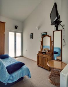 a bedroom with a bed and a mirror and a table at Apartments by the sea Prvic Luka, Prvic - 12064 in Prvić Luka