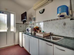 a kitchen with a sink and a counter top at Apartments by the sea Prvic Luka, Prvic - 12064 in Prvić Luka