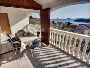 a balcony with a table and a view of the ocean at Apartments by the sea Prvic Luka, Prvic - 12064 in Prvić Luka