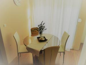 a dining room table with chairs and a bowl of flowers on it at Apartments with a parking space Murter - 12067 in Murter