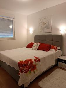 a bedroom with a large bed with red pillows at Apartments with WiFi Split - 12072 in Split