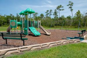 a park with a playground with a slide at Spacious 4 Bed Home near Orlando Gated Pool Access in Sanford