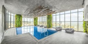 a rendering of a pool in a building with windows at Citadines Marina Halong in Ha Long