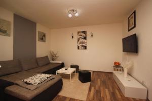 a living room with a couch and a table at Apartments for families with children Sisan, Medulin - 12199 in Ližnjan