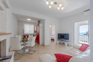 a living room with a couch and a dining room at Apartments by the sea Cove Zaglav, Korcula - 12208 in Prizba