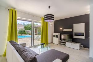 a living room with a couch and a tv at Family friendly house with a swimming pool Krsan - Vlasici, Central Istria - Sredisnja Istra - 12224 in Kršan