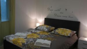 a bedroom with a bed with two towels on it at Family friendly house with a swimming pool Krsan - Vlasici, Central Istria - Sredisnja Istra - 12224 in Kršan