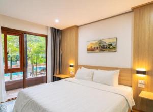 a bedroom with a large white bed and a window at New Champa Boutique Hotel in Vientiane +65 photos