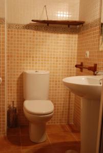 a bathroom with a toilet and a sink at Casa Rural Los Barreros in San Cristóbal de Segovia