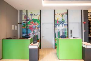 a room with a wall with a painting on it at ibis Styles Singapore Albert in Singapore