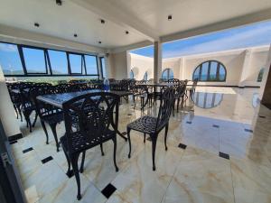 a group of tables and chairs in a room at Con Son Blue Sea Hotel in Con Dao