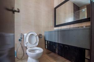 a bathroom with a white toilet and a mirror at Shaftsbury Cyberjaya by IdealHub in Cyberjaya