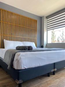 a bedroom with a large bed with a wooden headboard at Casa Joseffa in Fresnillo de González Echeverría