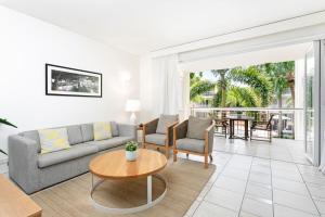 a living room with a couch and a table at Laguna on Hastings Noosa 127 in Noosa Heads