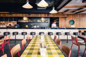 a long table with chairs and a bar at Tori's Luxury Historic Cottage - Walk Salamanca in Hobart