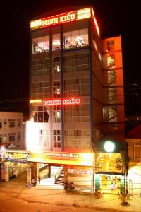 a building with a sign on it at night at Minh Kieu Hotel in My Tho