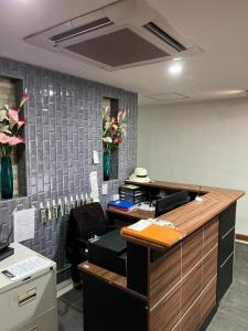 an office with a desk with flowers on the wall at Galaxy Suites in Pattaya South