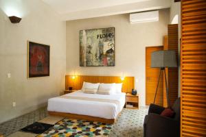 a hotel room with a bed and a couch at Casa Carmen Morelos in Oaxaca City