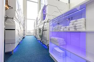 a hospital aisle with purple and white towels at CAPS LOCK Airport Hotel in Astana