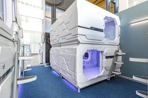 an empty hospital room with a large white machine at CAPS LOCK Airport Hotel in Astana