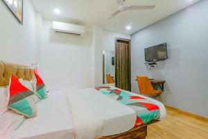 a hotel room with a bed and a tv at FabExpress The Mall Inn in Kānpur