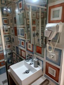 a bathroom with a white sink and a mirror at Affittacamere Il Chiostrino Guest House in Florence